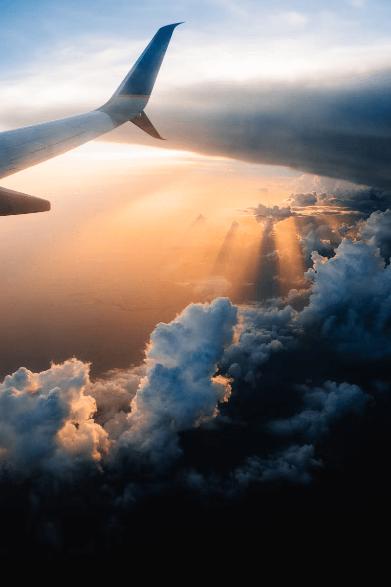 Airplane flying through the golden hour